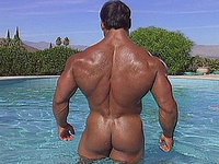 An extremely tan, muscled hunk goes for a naked swim