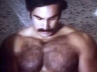 Alpha male with a hairy chest plays with his pecker